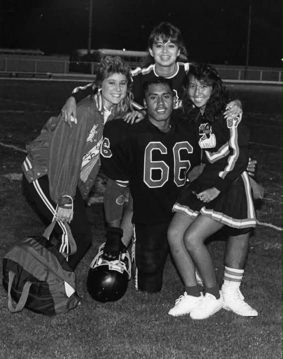McCann in his football uniform with cheerleaders