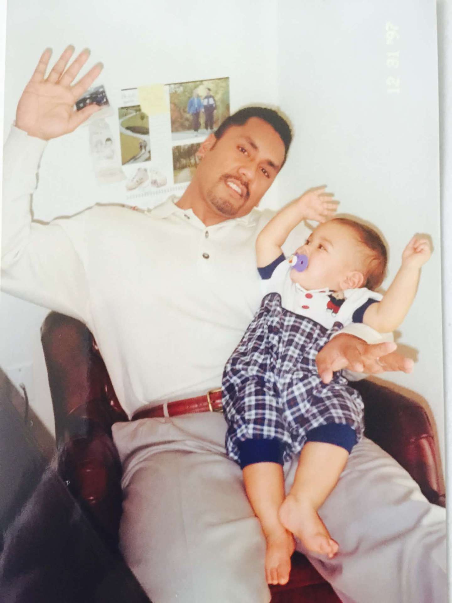 Dad relaxing in a chair with baby on his lap