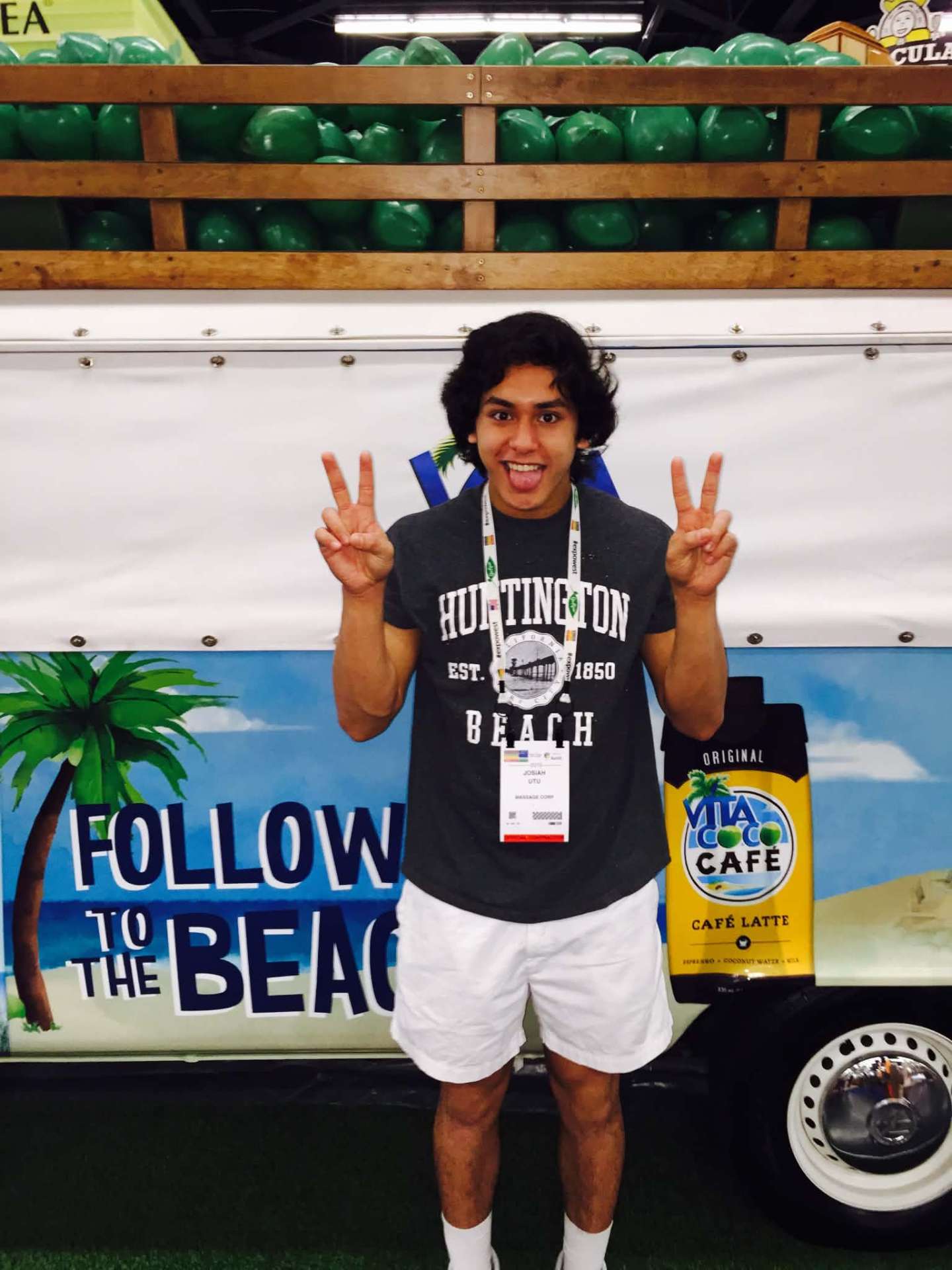 Josiah throwing up peace signs in a Huntington Beach tee