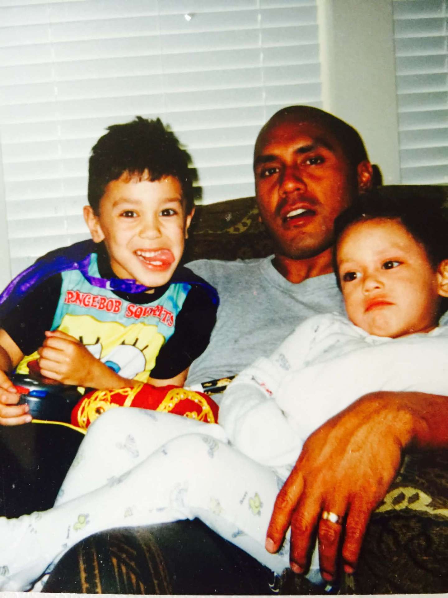 Dad on the couch with two kids