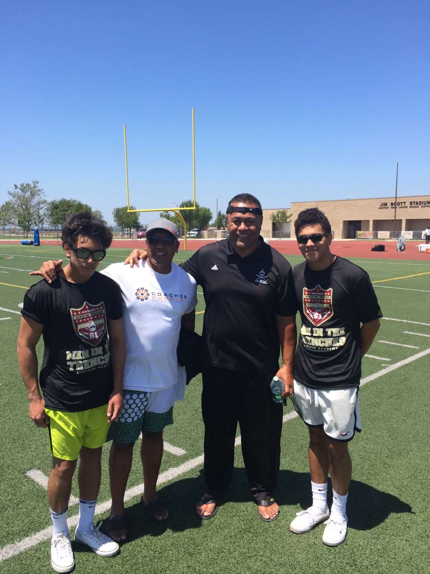 Dad and the boys with a coach at Jim Scott Stadium
